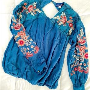 Francesca’s blue blouse with floral detailing